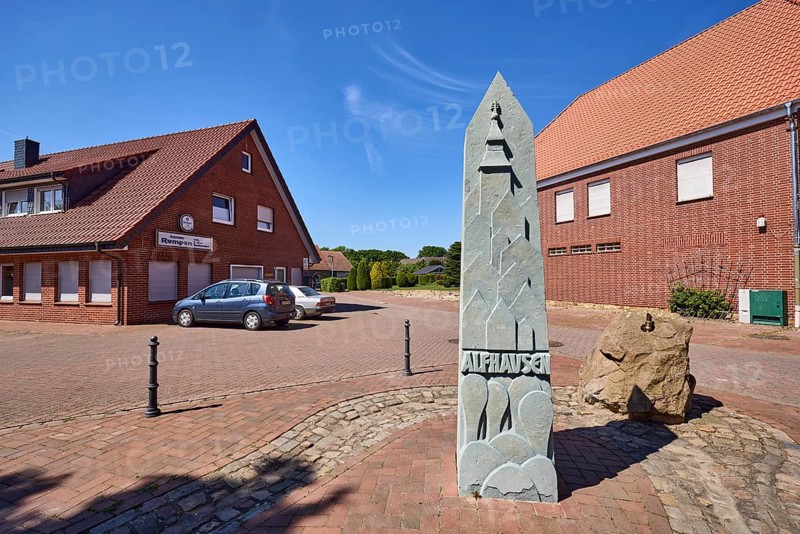 1000 year fountain, Rempen restaurant, clinker brick building, general development, pointed roofs, clinker brick pavement, concrete paving stone road, vehicles, blue sky, cirrostratus clouds, intersection of Hauptstraße, Nonnenpfad and In den Gärten, Alfhausen, district of Osnabrück, Lower Saxony, Germany