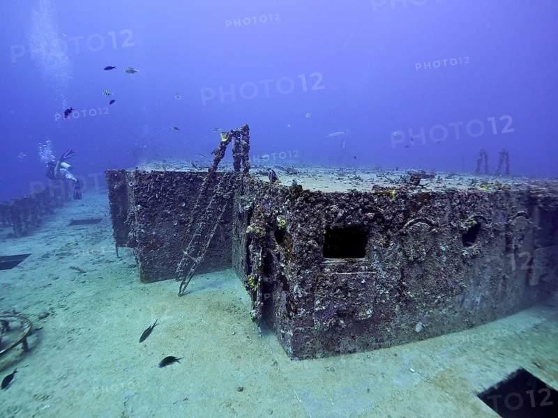 Rusty shipwreck with corals and fish in deep water. Dive site wreck of the USS Spiegel Grove, John Pennekamp Coral Reef State Park, Key Largo, Florida Keys, Florida, USA