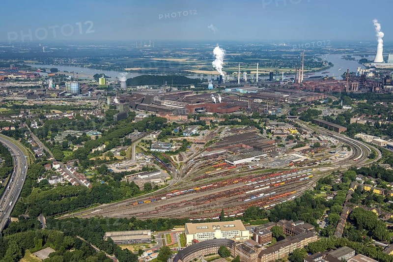 Aerial view, goods train station, thyssenkrupp Steel Europe factory premises, river Rhine with STEAG cogeneration plant Walsum, Marxloh, Duisburg, Ruhr area, North Rhine-Westphalia, Germany, DE, Europe, commercial enterprises, commercial area, commercial park, commercial site, commercial use, greenhouse, industrial area, industrial building, industrial site, power plant, aerial view, aerial photography, aerial photography, aerial photography, overview, bird's-eye view, birds-eyes view, overview