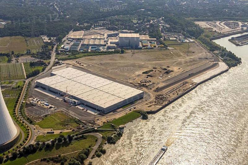 Aerial view, STEAG cogeneration plant Walsum, development and new warehouses logport VI, river Rhine, Alt-Walsum, Duisburg, Ruhr area, North Rhine-Westphalia, Germany, construction work, construction area, construction site, building plots, construction project, construction site, DE, development, Europe, industrial area, commercial area, commercial use, cogeneration plant, industrial facilities, industrial area, industrial site, capacity requirements, aerial view, aerial photography, aerial photography, new construction, overview, bird's-eye view, birds-eyes view, former Walsum colliery, logport VI, overview