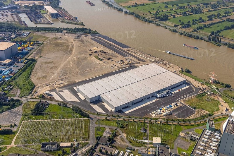Aerial view, STEAG cogeneration plant Walsum, development and new warehouses logport VI, river Rhine, Alt-Walsum, Duisburg, Ruhr area, North Rhine-Westphalia, Germany, construction work, construction area, construction site, building plots, construction project, construction site, DE, development, Europe, industrial area, commercial area, commercial use, cogeneration plant, industrial facilities, industrial area, industrial site, capacity requirements, aerial view, aerial photography, aerial photography, new construction, overview, bird's-eye view, birds-eyes view, former Walsum colliery, logport VI, overview
