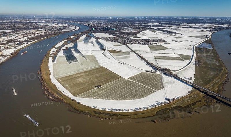 Aerial view, river Rhine, Rheinaue Ehingen with view of Mündelheim, Krefeld-Uerdingen bridge, snow-covered meadows and fields, Ürdingen, Krefeld, Ruhr area, North Rhine-Westphalia, Germany, DE, Europe, freight transport, cargo ships, aerial view, aerial photography, aerial photography, shipping, snow, overview, bird's eye view, meadows and fields, winter, birds-eyes view, cleared roads, overview