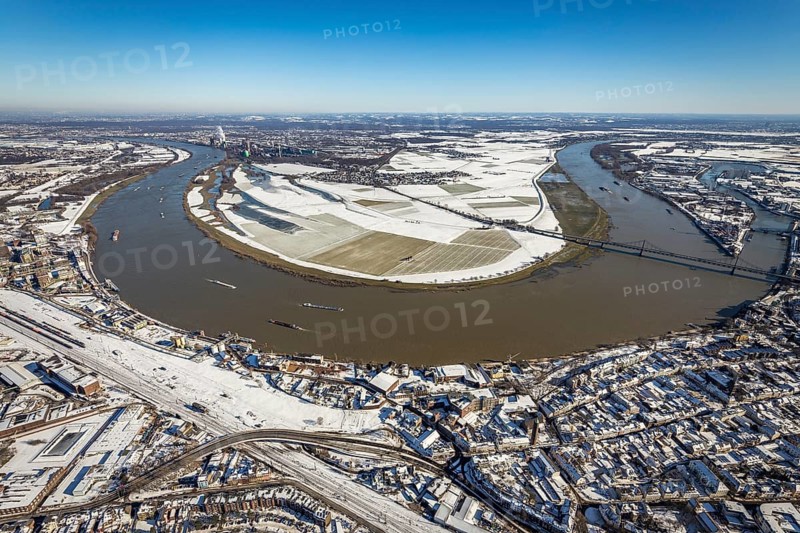 Aerial view, river Rhine, Rheinaue Ehingen with view of Mündelheim, Krefeld-Uerdingen bridge, snow-covered meadows and fields, Ürdingen, Krefeld, Ruhr area, North Rhine-Westphalia, Germany, DE, Europe, freight transport, cargo ships, aerial view, aerial photography, aerial photography, shipping, snow, overview, bird's eye view, meadows and fields, winter, birds-eyes view, cleared roads, overview