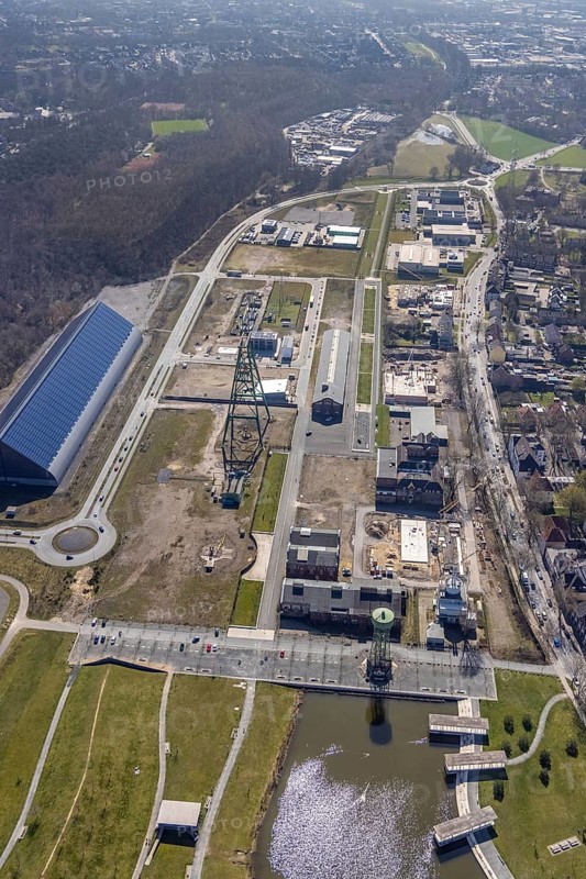Aerial view, Bergpark Lohberg, former Lohberg colliery site, winding tower, water tower, Lohberg colliery workshop, Oberlohberg, Dinslaken, Ruhr area, North Rhine-Westphalia, Germany, construction area, construction site, construction project, CO2-neutral site, DE, Europe, design concept, commercial area, commercial use, green area, Hünxer Straße, industrial plants, industrial area, industrial site, Lohberg power station, Lohberg creative quarter, roundabout, culture, aerial view, aerial photography, aerial photography, Lower Rhine, Ober-Lohberg-Allee, park, overview, bird's-eye view, birds-eyes view, former Lohberg coal mine, former colliery site, creative use, cultural use, overview