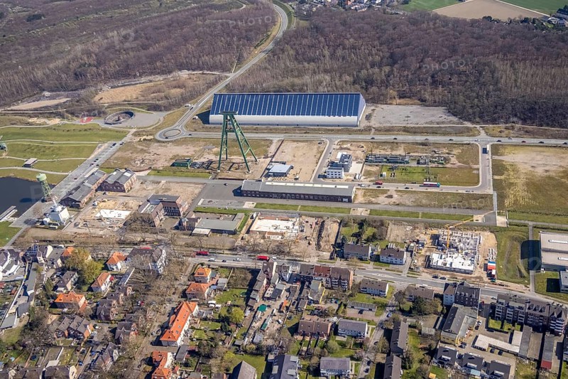 Aerial view, Bergpark Lohberg, former Lohberg colliery site, winding tower, water tower, Lohberg colliery workshop, Oberlohberg, Dinslaken, Ruhr area, North Rhine-Westphalia, Germany, construction area, construction site, construction project, CO2-neutral site, DE, Europe, design concept, commercial area, commercial use, green area, Hünxer Straße, industrial plants, industrial area, industrial site, Lohberg power station, Lohberg creative quarter, roundabout, culture, aerial view, aerial photography, aerial photography, Lower Rhine, Ober-Lohberg-Allee, park, overview, bird's-eye view, birds-eyes view, former Lohberg coal mine, former colliery site, creative use, cultural use, overview