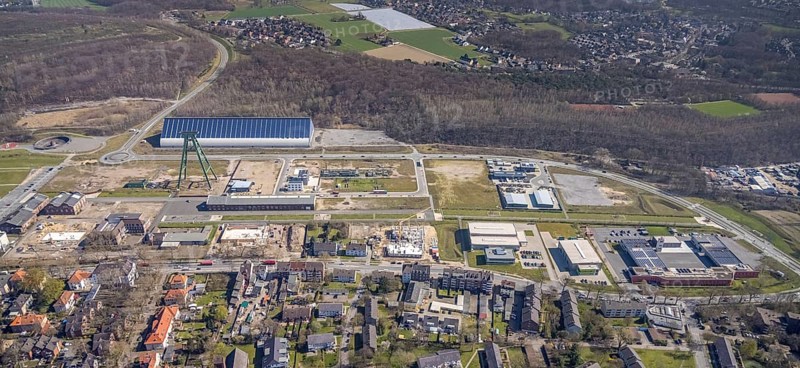 Aerial view, Bergpark Lohberg, former Lohberg colliery site, winding tower, water tower, Lohberg colliery workshop, Oberlohberg, Dinslaken, Ruhr area, North Rhine-Westphalia, Germany, construction area, construction site, construction project, CO2-neutral site, DE, Europe, design concept, commercial area, commercial use, green area, Hünxer Straße, industrial plants, industrial area, industrial site, Lohberg power station, Lohberg creative quarter, roundabout, culture, aerial view, aerial photography, aerial photography, Lower Rhine, Ober-Lohberg-Allee, park, overview, bird's-eye view, birds-eyes view, former Lohberg coal mine, former colliery site, creative use, cultural use, overview