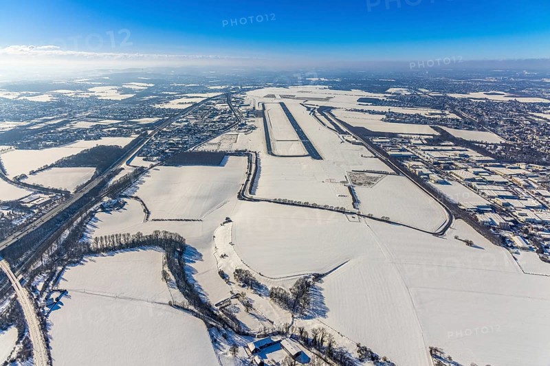 Aerial photo, Dortmund airport in winter, Wickede, Dortmund, Ruhr area, North Rhine-Westphalia, Germany, DE, Europe, flight mission, airport, airfield, runway, aerial photo, aerial photography, aerial photography, snow, runway, overview, bird's-eye view, winter, onset of winter, winter landscape, birds-eyes view, overview, cleared runway, taxiways terminal, general aviation, EDLW, General aviation, city limits Holzwickede