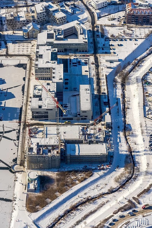 Aerial view, snow-covered Phoenix Lake, construction site of a retirement home, Hörde, Dortmund, Ruhr area, North Rhine-Westphalia, Germany, DE, Europe, commercial buildings, aerial view, aerial photography, aerial photography, snow, lake, overview, bird's eye view, winter, winter onset, winter landscape, birds-eyes view, overview, ice, ice surface, thin ice, break in the ice, breaks in the ice, snow-covered ice surface, artificial lake