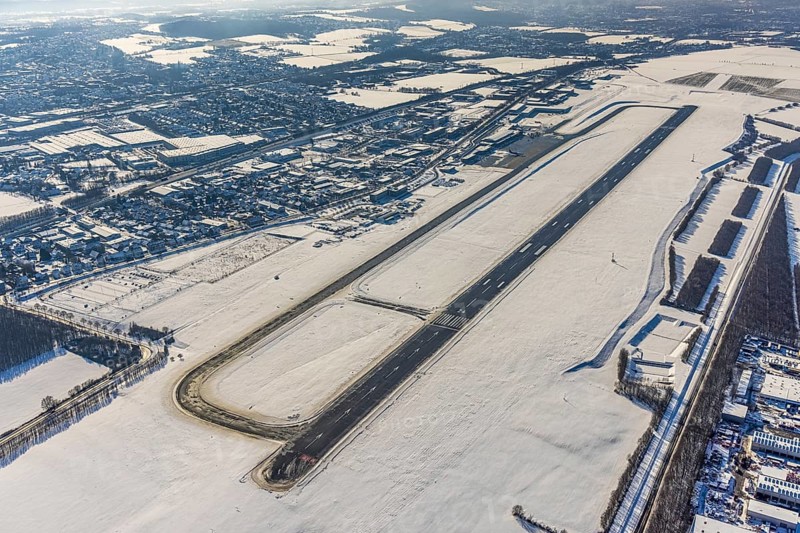 Aerial photo, Dortmund airport in winter, Wickede, Dortmund, Ruhr area, North Rhine-Westphalia, Germany, DE, Europe, flight mission, airport, airfield, runway, aerial photo, aerial photography, aerial photography, snow, runway, overview, bird's-eye view, winter, onset of winter, winter landscape, birds-eyes view, overview, cleared runway, taxiways terminal, general aviation, EDLW, General aviation, city limits Holzwickede