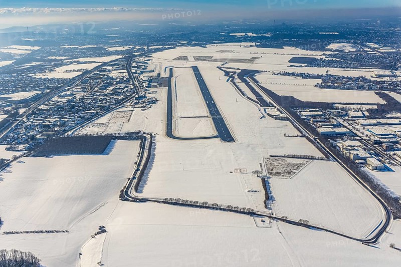 Aerial photo, Dortmund airport in winter, Wickede, Dortmund, Ruhr area, North Rhine-Westphalia, Germany, DE, Europe, flight mission, airport, airfield, runway, aerial photo, aerial photography, aerial photography, snow, runway, overview, bird's-eye view, winter, onset of winter, winter landscape, birds-eyes view, overview, cleared runway, taxiways terminal, general aviation, EDLW, General aviation, city limits Holzwickede