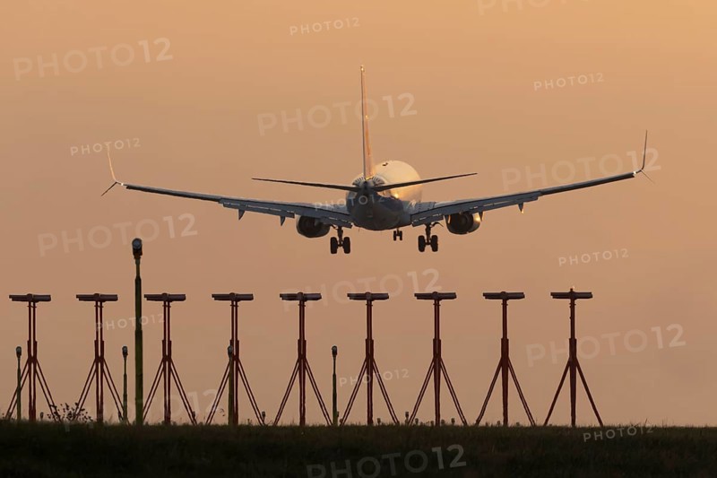 Boeing 737 jet aircraft of Ryanair airlines in flight landing at sunset at London Stansted airport, Essex, England, United Kingdom