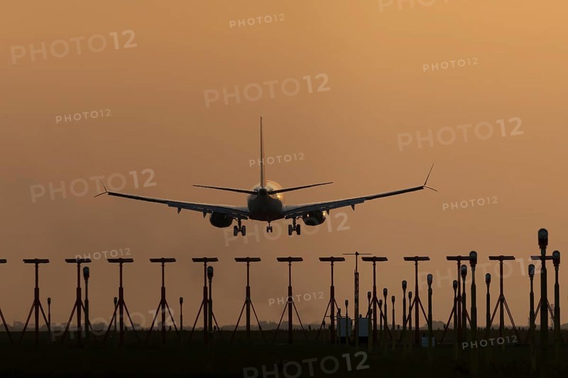 Boeing 737 jet aircraft of Ryanair airlines in flight landing at sunset at London Stansted airport, Essex, England, United Kingdom