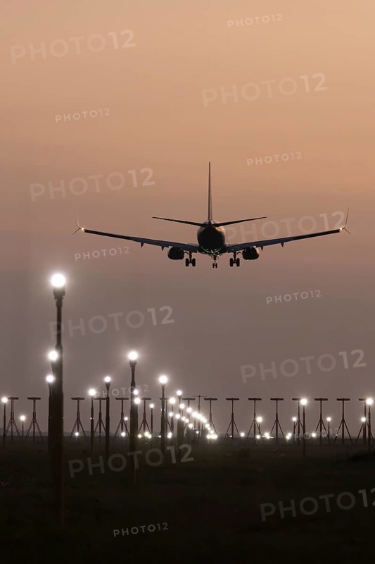 Boeing 737 jet aircraft of Ryanair airlines in flight landing at sunset at London Stansted airport, Essex, England, United Kingdom