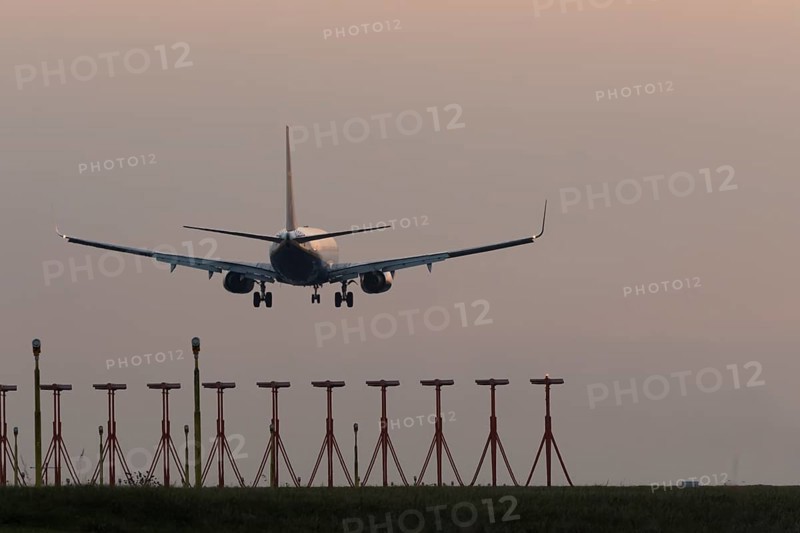 Boeing 737 jet aircraft of Ryanair airlines in flight landing at sunset at London Stansted airport, Essex, England, United Kingdom