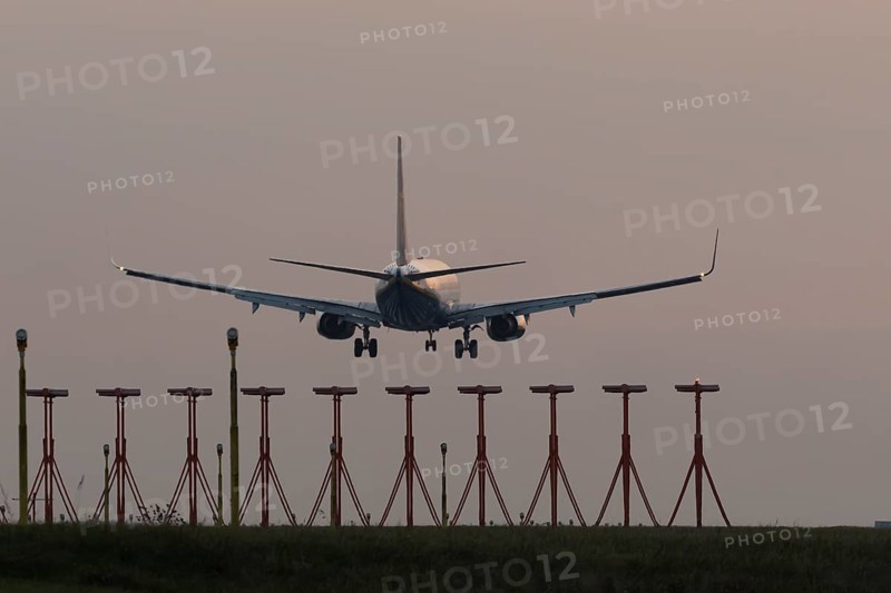 Boeing 737 jet aircraft of Ryanair airlines in flight landing at sunset at London Stansted airport, Essex, England, United Kingdom