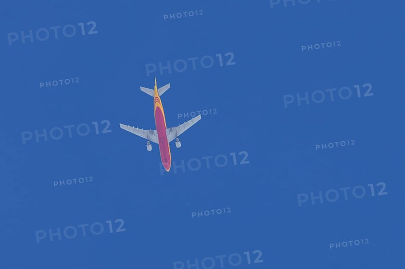 Boeing 767 jet aircraft of DHL cargo airlines in flight in a blue sky, England, United Kingdom