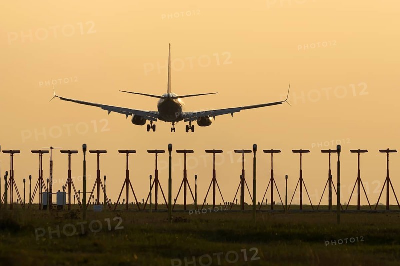 Boeing 737 jet aircraft of Ryanair airlines in flight landing at sunset at London Stansted airport, Essex, England, United Kingdom