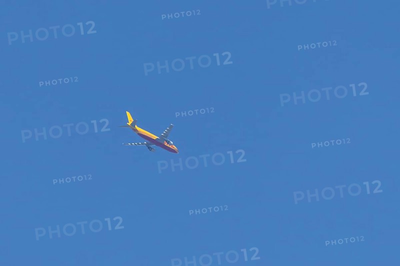 Boeing 767 jet aircraft of DHL cargo airlines in flight in a blue sky, England, United Kingdom