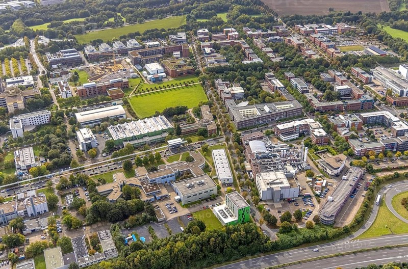 Aerial view of TZDO - TechnologieZentrumDortmund GmbH, Technische Universität Dortmund Campus Nord with the Technology Centre and EMC Test North Rhine-Westphalia GmbH EMC Competence Centre and construction site for the CALEDO research centre next to the Faculty of Computer Science in the Oespel district of Dortmund, Ruhr area, North Rhine-Westphalia, Germany, A40 motorway, construction work, construction site, building plots, building avenue, construction project, building site, education, educational institution, Campus North, DE, Dortmund, Elmos Semiconductor SE, Emil-Figge-Straße, Europe, distant view, green area technology park, aerial view, aerial photograph, aerial photography, aerial photography, new building, TU Dortmund, Dortmund University of Technology, overview, University of Dortmund, bird's-eye view, overview