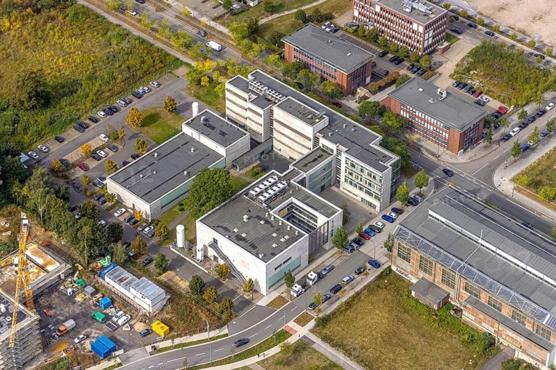 Phoenix-West area with company buildings MST Factory and ION-GAS GmbH on Konrad-Adenauer-Allee in the Hörde district of Dortmund, Ruhr area, North Rhine-Westphalia, Germany, Bartels Mikrotechnik GmbH, DE, Dortmund, Europe, commercial enterprises, commercial area, industrial estate, business park, commercial location, commercial use, industrial area, industrial building, industrial location, innovation location, aerial view, aerial photograph, aerial photography, aerial photography, Micronit GmbH, Phönix-West, overview, bird's-eye view, birds-eyes view, former blast furnace plant, overview, temicon GmbH