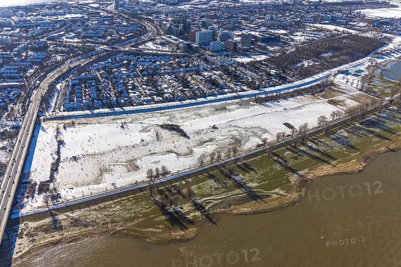 Aerial view, ice rink, ice skaters and pedestrians on frozen Rhine meadow in Lörrick near the Theodor-Heuss-Bridge, Niederkassel, Düsseldorf, Rhineland, North Rhine-Westphalia, Germany, DE, Europe, shapes and colours, aerial view, aerial photography, aerial photography, ice skating, snow, overview, bird's eye view, winter, birds-eyes view, overview