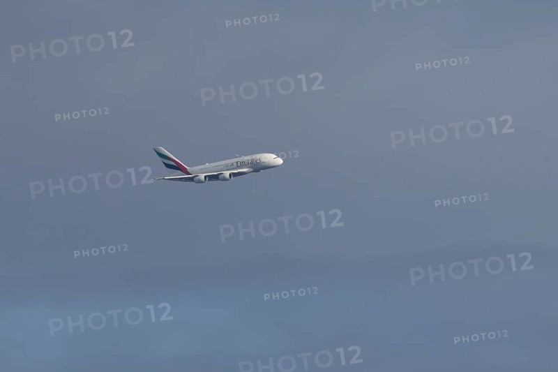 Airbus A380 jet passenger aircraft of Emirates airlines flying in a blue sky, England, United Kingdom