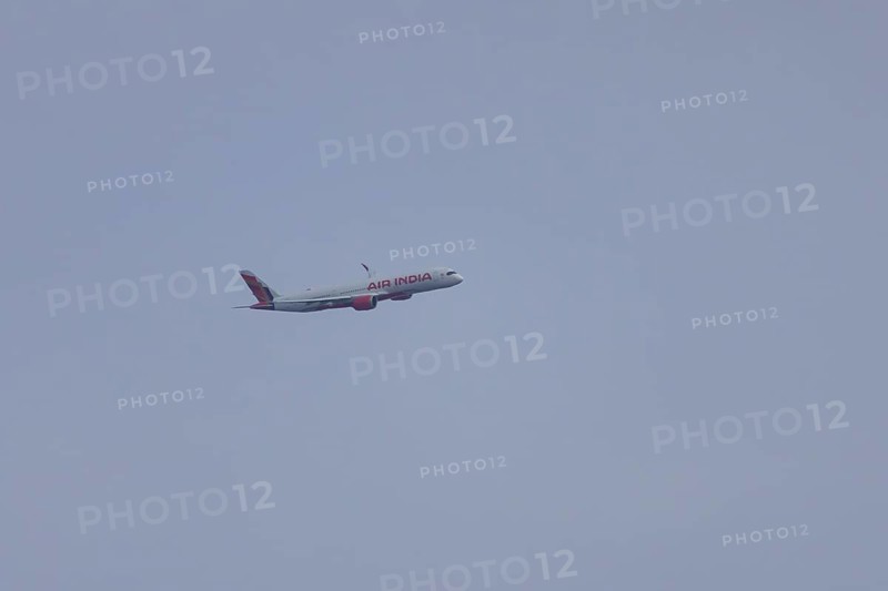 Aircraft of Air India airways in flight in a blue sky, London, England, United Kingdom