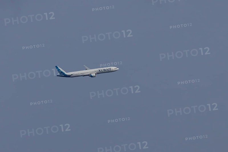 Boeing 777 jet passenger aircraft of Kuwait airlines in flight in a blue sky, England, United Kingdom