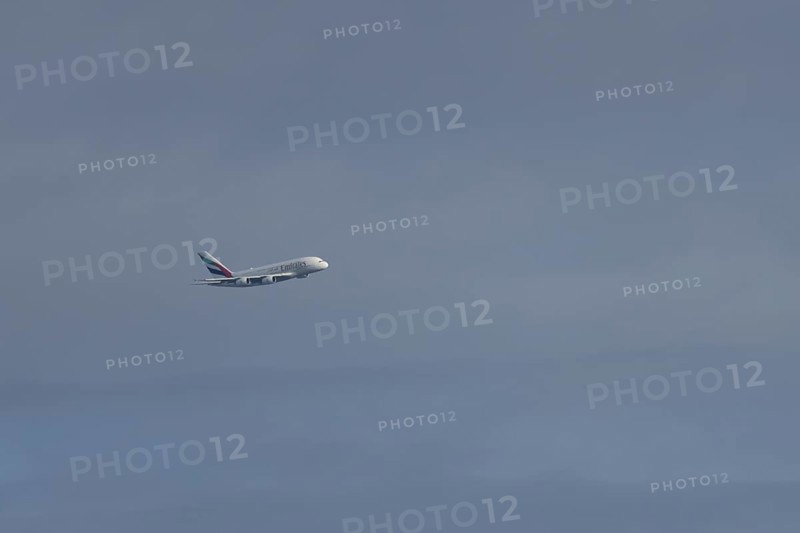 Airbus A380 jet passenger aircraft of Emirates airlines flying in a blue sky, England, United Kingdom