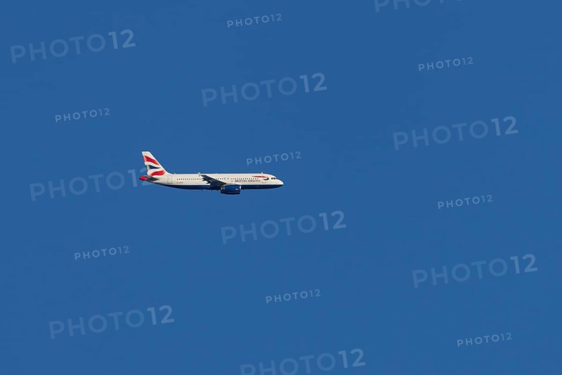 Airbus A320-232 jet passenger aircraft of British Airways airlines in flight in a blue sky, London, England, United Kingdom