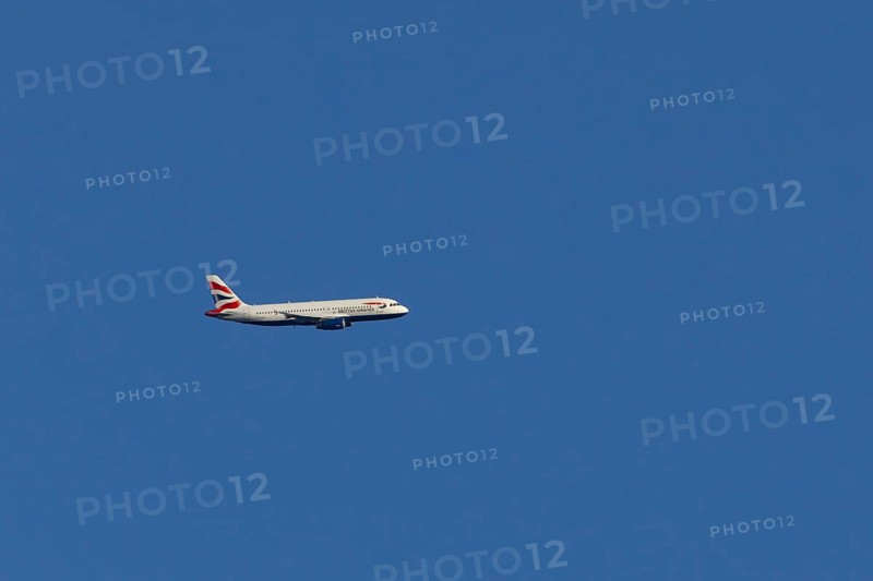 Airbus A320-232 jet passenger aircraft of British Airways airlines in flight in a blue sky, London, England, United Kingdom