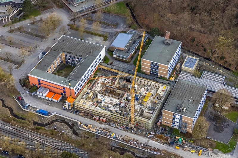 Aerial view, construction site and new building at Berufskolleg Berliner Platz, Hüsten, Arnsberg, Sauerland, North Rhine-Westphalia, Germany, construction work, construction area, construction site, building plots, construction crane, construction measure, construction project, construction site, education, educational institution, DE, Europe, college school, teaching institute, aerial view, aerial photography, aerial photography, new building, school, overview, bird's-eye view, overview
