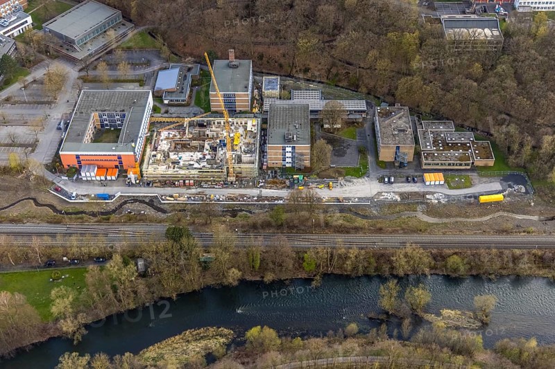 Aerial view, construction site and new building at Berufskolleg Berliner Platz, Hüsten, Arnsberg, Sauerland, North Rhine-Westphalia, Germany, construction work, construction area, construction site, building plots, construction crane, construction measure, construction project, construction site, education, educational institution, DE, Europe, college school, teaching institute, aerial view, aerial photography, aerial photography, new building, school, overview, bird's-eye view, overview, new course of stream, tree stream