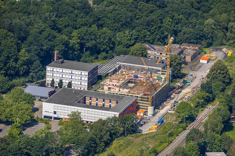 Aerial view, construction site and new building, Berufskolleg Berliner Platz, Hüsten, Arnsberg, Sauerland, North Rhine-Westphalia, Germany, construction work, construction area, construction site, building plots, construction crane, construction measure, construction project, construction site, education, educational institution, DE, Europe, Hochsauerlandkreis, college school, teaching institute, aerial view, aerial photography, aerial photography, new building, school, overview, bird's-eye view, overview
