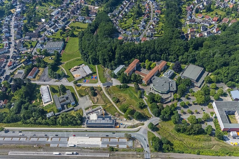 Aerial view, construction site, new building extension for Hochsauerlandkreis vocational college, Neheim-Hüsten station, Berliner Platz cultural centre, Franz-Stock-Gymnasium, Sauerland-Kolleg Arnsberg, Hüsten, Arnsberg, Sauerland, North Rhine-Westphalia, Germany, railway tracks, station, platform, construction work, construction site, building site, construction project, building site, education, educational institution, DE, Deutsche Bahn AG, Europe, grammar school, main railway station, main station, Hochsauerlandkreis, college, teaching institute, aerial view, aerial photography, aerial photography, new building, school, overview, bird's-eye view, overview