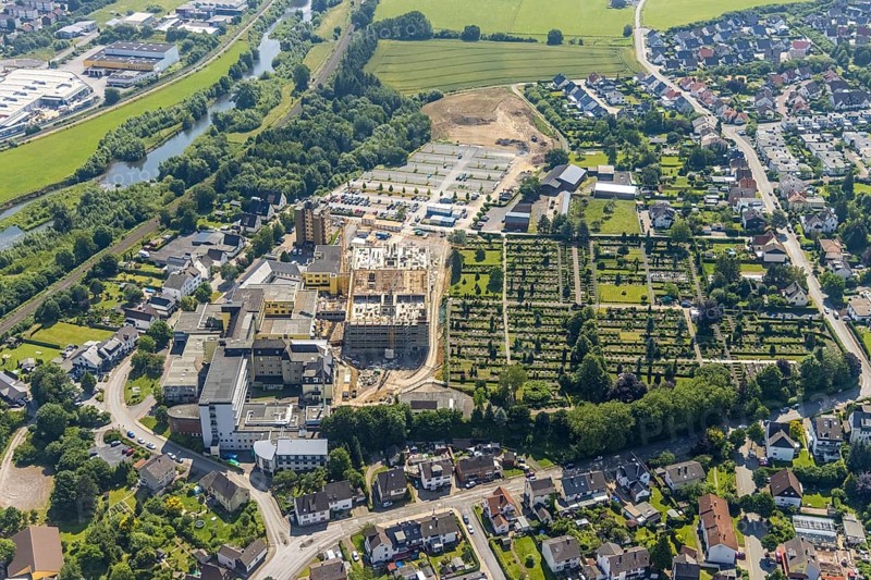 Aerial view, construction site and extension of Hochsauerland Karolinen-Hospital Hüsten, Hüsten, Arnsberg, Sauerland, North Rhine-Westphalia, Germany, construction work, construction area, building site, building plots, construction project, construction site, burial site, DE, Europe, cemetery, memorial, health care, Gottesacker, graves, burial ground, Hochsauerlandkreis, hospital, Kath. St. Petri cemetery, clinic, hospital, hospital centre, hospital, aerial view, aerial photography, aerial photography, medical facility, medical aid, new building, resting place, overview, bird's-eye view, bird's-eye view, overview, medical care