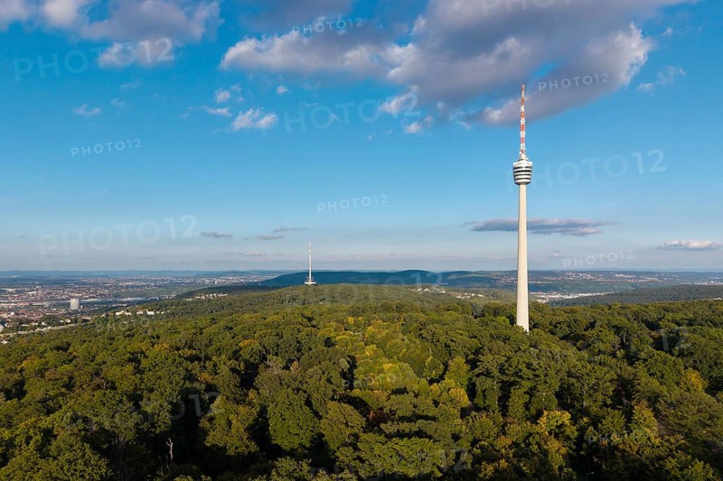 Modern television tower above a green forest and soft clouds in the blue sky, Stuttgart-Degerloch, Baden-Württemberg, Germany