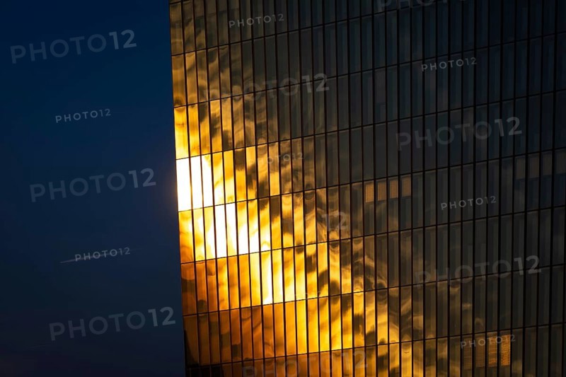 The light of the setting sun is reflected in the glass façade of the European Central Bank (ECB) in Frankfurt am Main, Osthafen, Frankfurt am Main, Hesse, Germany