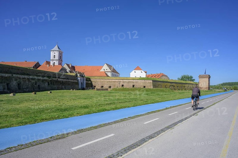 Fortress with church tower and cycle path and blue tread in the foreground, Tvrda, Osijek, Osijek-Baranja County, Croatia