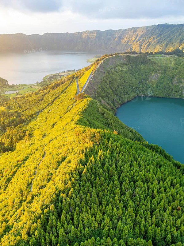 Lake Santiago and Blue Lake. Sete Cidades Caldera at Sunset. Lush Green Hills with Forest. Azores, Sao Miguel Island. Portugal. Aerial View