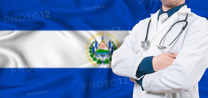 El Salvador healthcare concept. Male doctor on El Salvador flag. Doctor with crossed arms on El Salvador flag