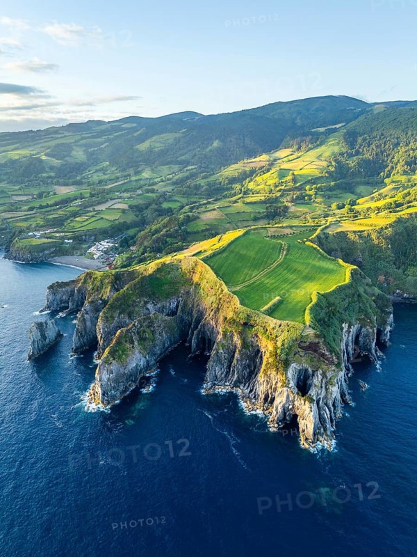 Cape Furado, Rocky Cliffs, Hills, Green Lush Fields, Pasturelands and Atlantic Ocean at Sunrise. Azores, Sao Miguel Island. Portugal. Aerial View