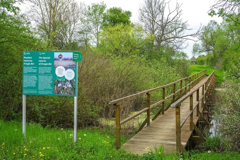 Information board and wooden bridge into the Krapje Dol nature reserve, Krapje, Sisak-Moslavina County, Croatia