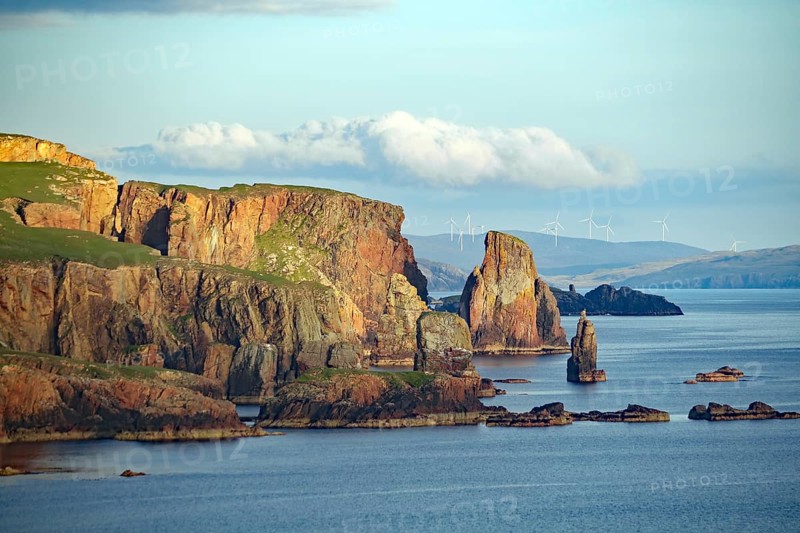 Cliffs and rock formations by the sea with wind turbines in the background, Eshaness, Shetland Islands, Scotland, Great Britain