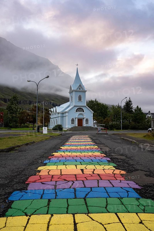 Church with rainbow pedestrian path in the town of Seyðisfjörður, East Iceland, Iceland