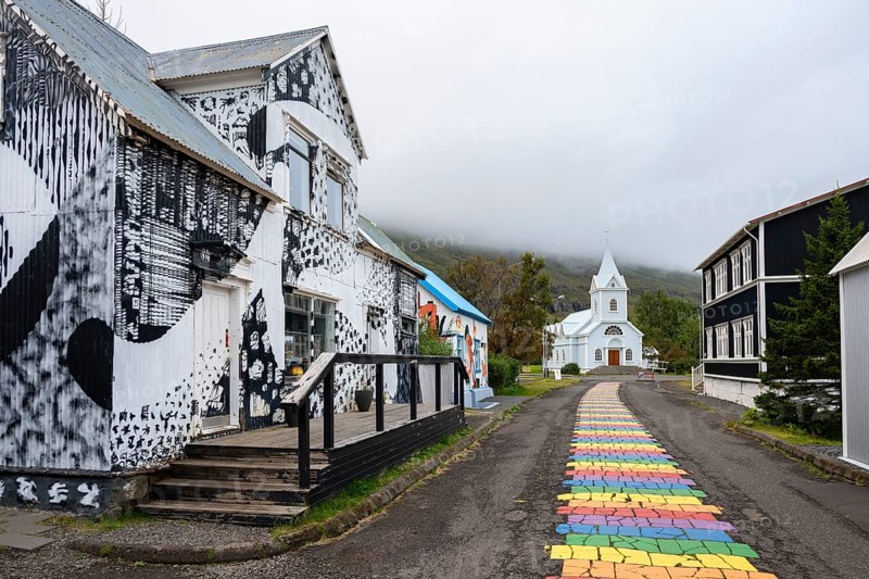 Church with rainbow pedestrian path in the town of Seyðisfjörður, East Iceland, Iceland