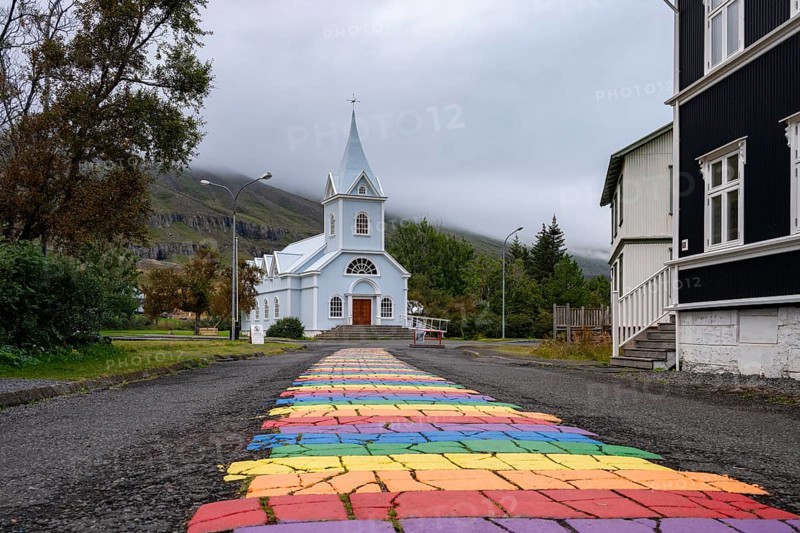 Church with rainbow pedestrian path in the town of Seyðisfjörður, East Iceland, Iceland