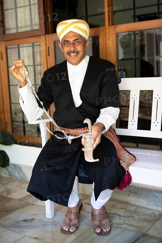 Indian man, 63 years old, from the Kodava clan in traditional dress showing a traditional dagger sheath, Coorg, Karnataka, India