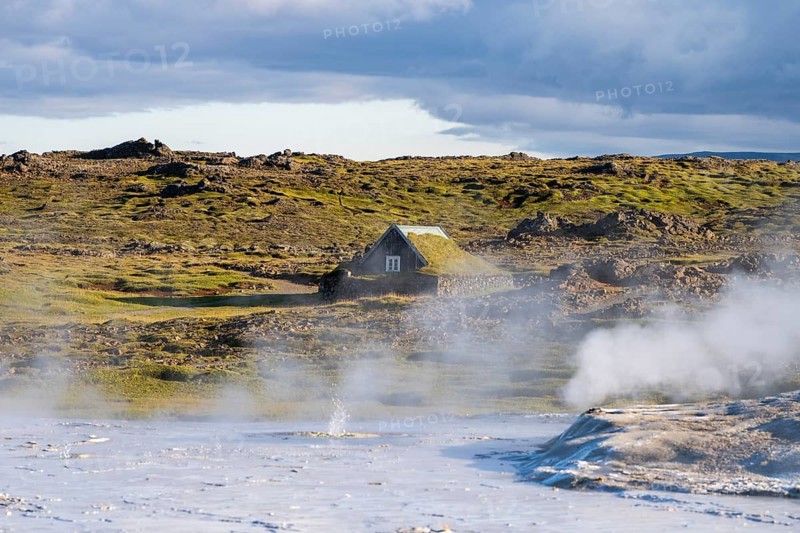 Steaming springs and traditional house at the Hveravellir geothermal area, Icelandic Highlands, Iceland