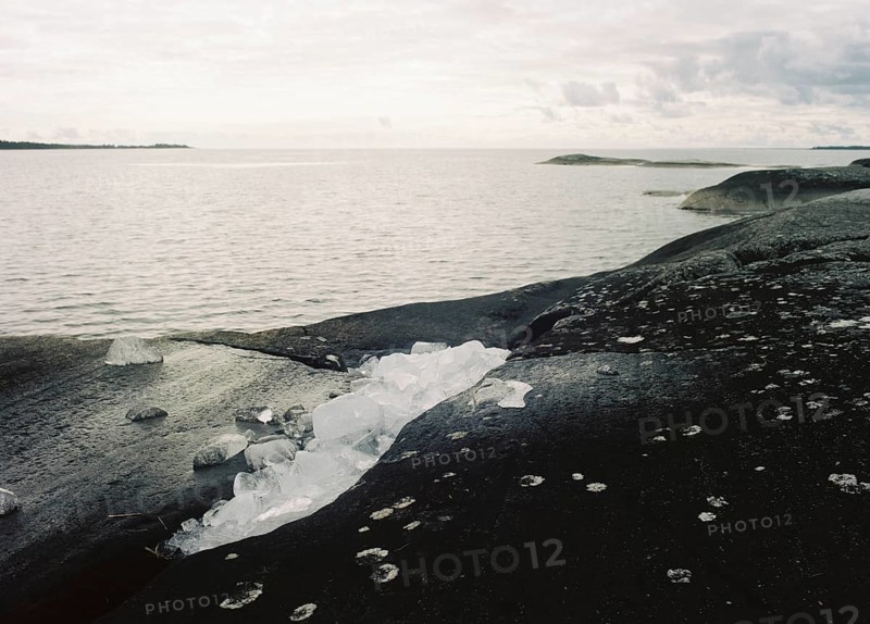 Ice remains from winter on the rocky shore of Lake Vänern, monochrome, analogue, Värmland, Sweden